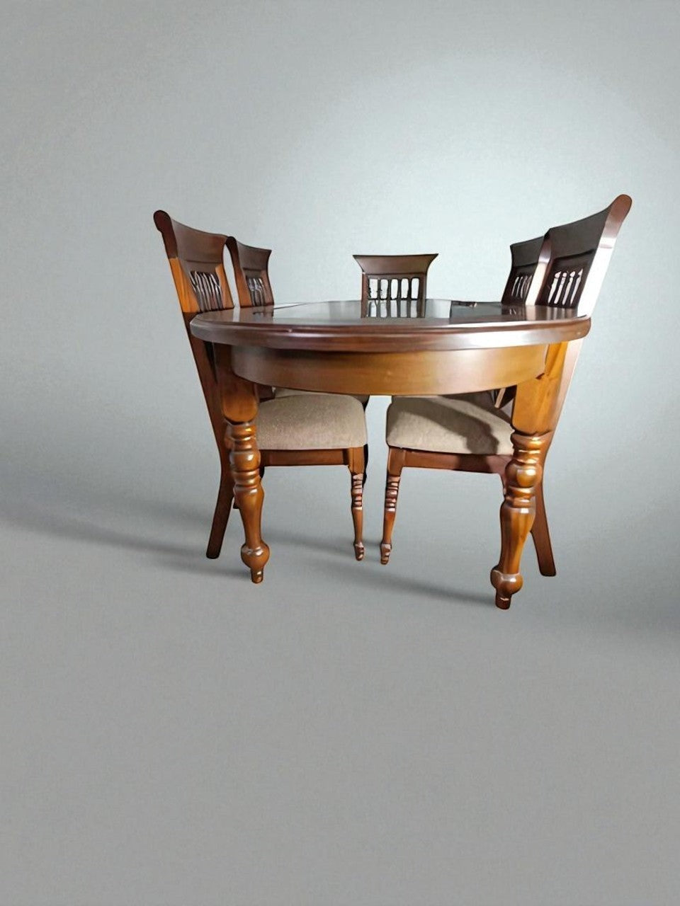 Fabrica de Muebles Wood dining set with round glass-top table and four upholstered chairs, featuring turned wood legs and ornate chair backs.